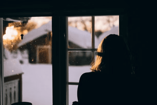 A quiet, reflective moment representing the experience of grief during holidays and anniversaries.